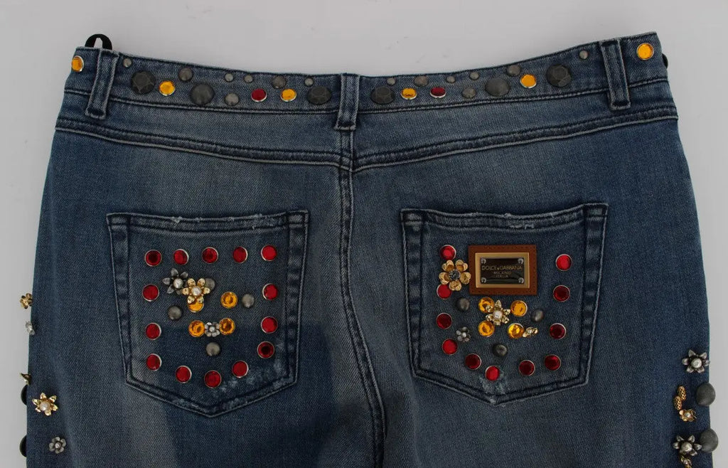 Dark blue boyfriend jeans with crystal rose and heart embellishments and rolled cuffs.