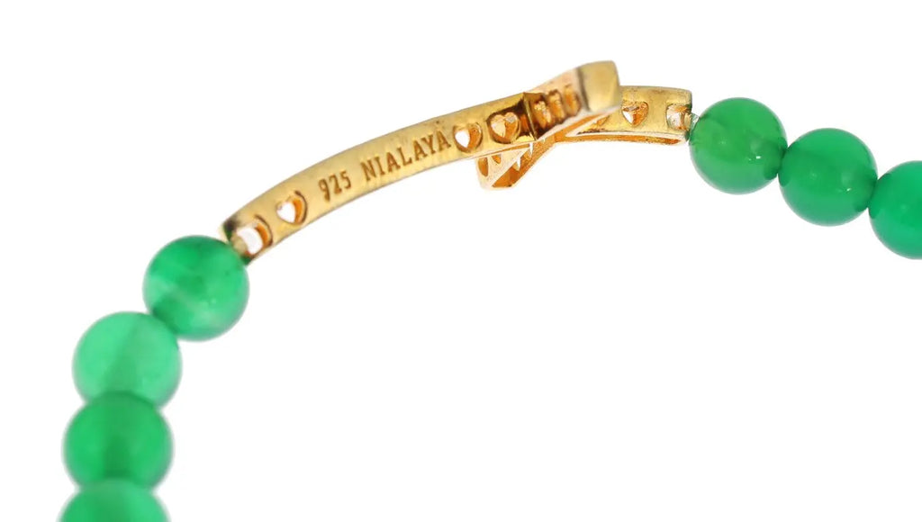 Green jade bead bracelet with gold-plated CZ cross and round gold accent bead.