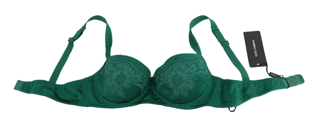 Green silk stretch bra with floral lace detail and adjustable straps on black mannequin torso.