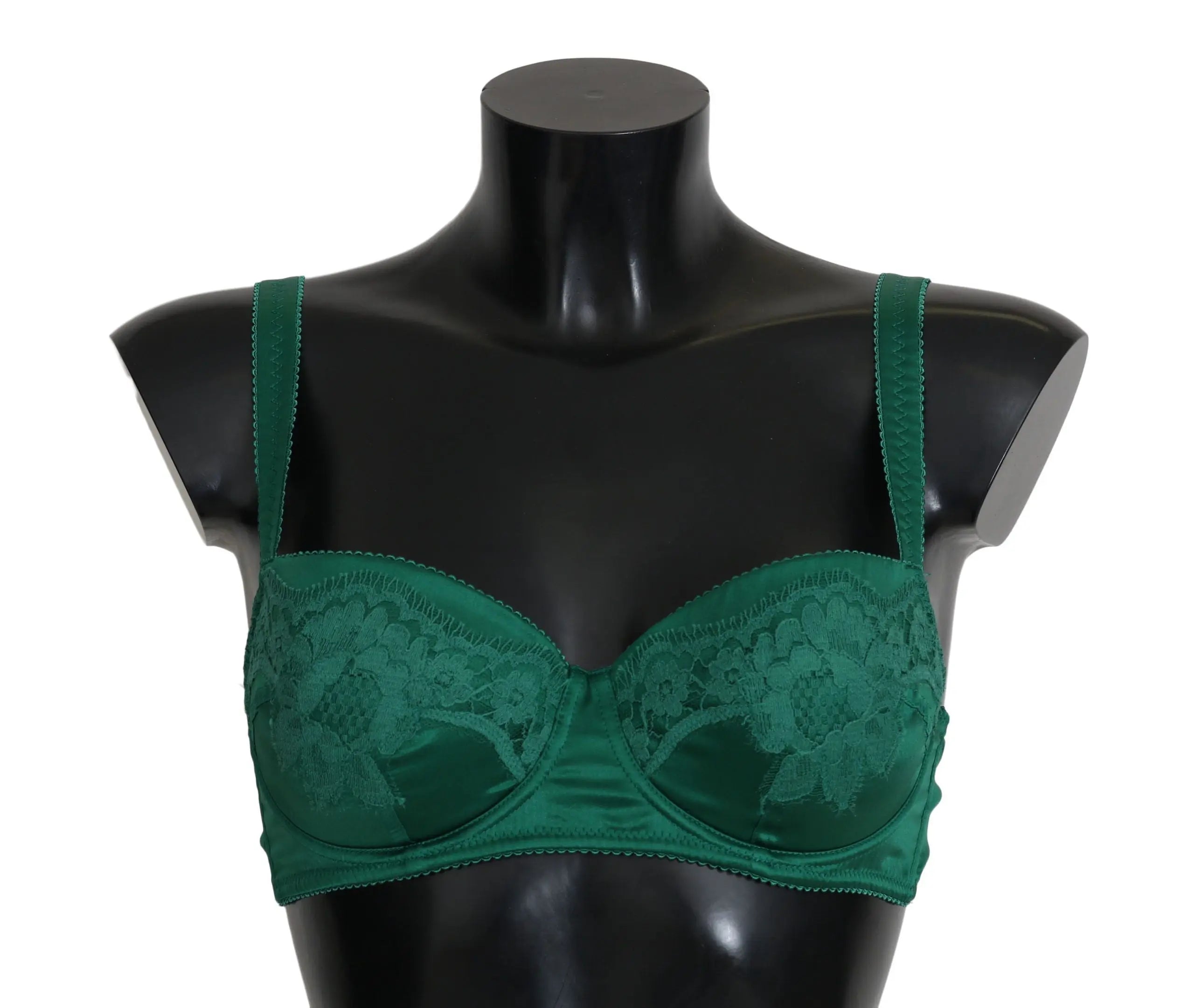 Green silk stretch bra with floral lace detail and adjustable straps on black mannequin torso.