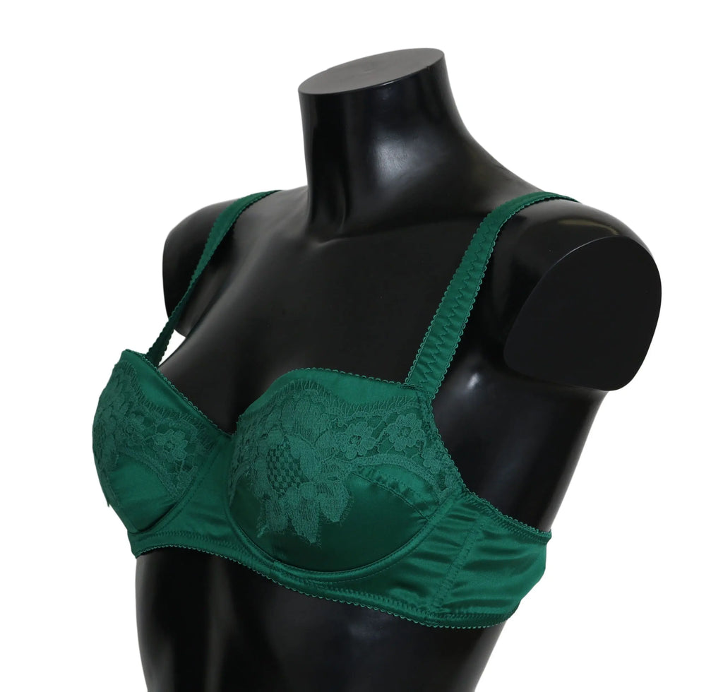 Green silk stretch bra with floral lace detail and adjustable straps on black mannequin torso.