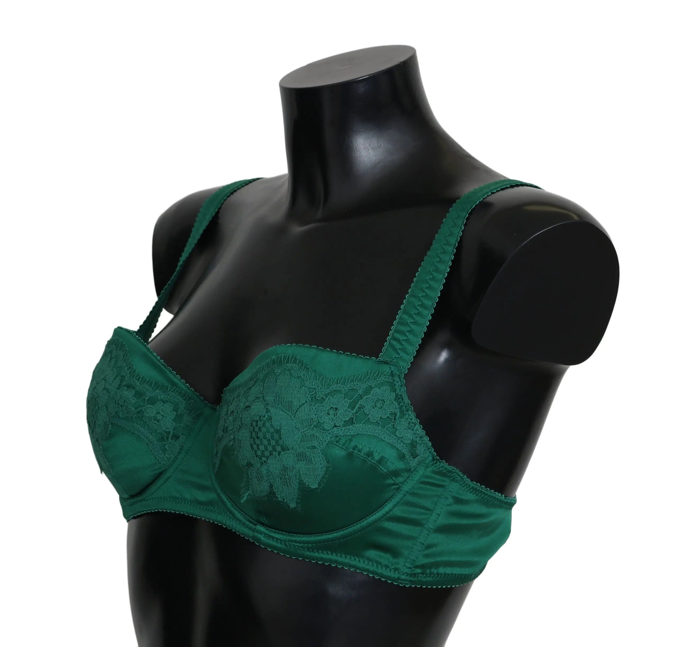 Green silk stretch bra with floral lace detail and adjustable straps on black mannequin torso.